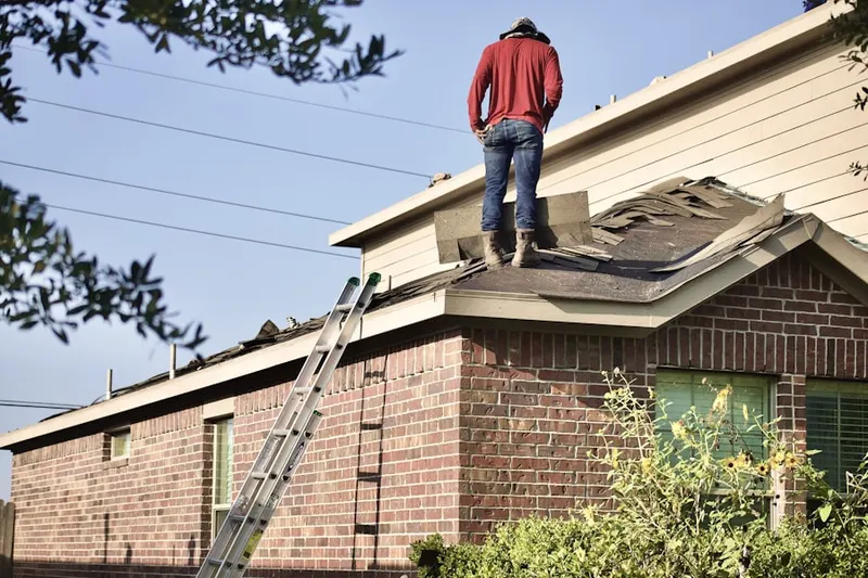 Professional roofer working on a residential roof in Byram
